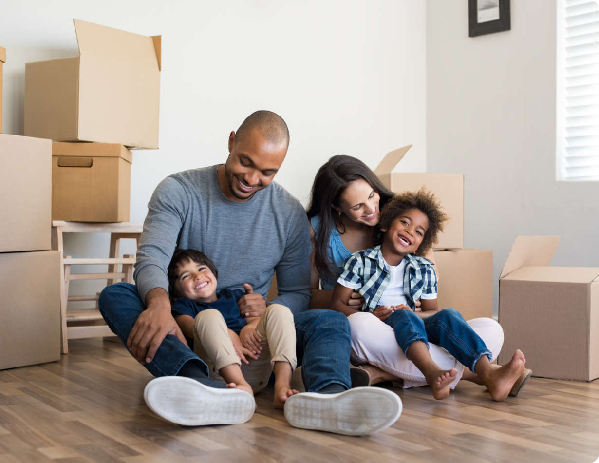 Family sitting in new home with boxes